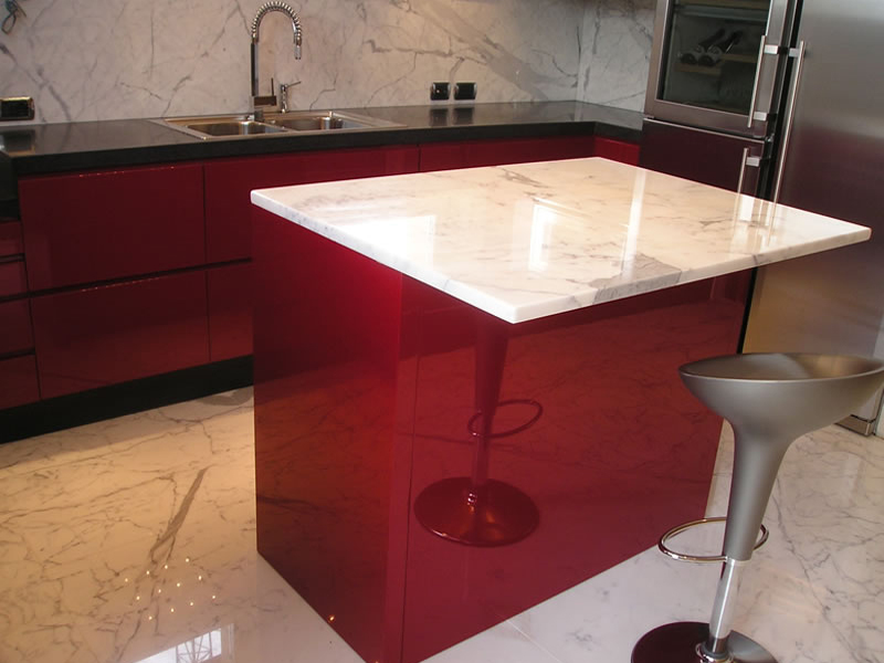 Glossy lacquered kitchen with island and marble top